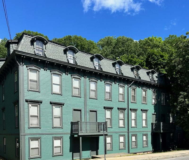 A Green Building On A Street Corner