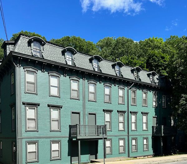 A Green Building On A Street Corner